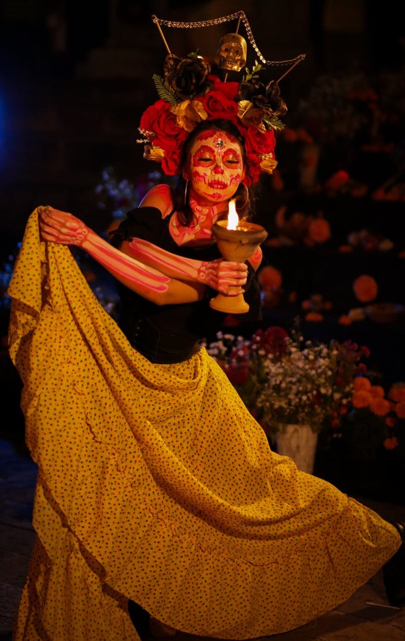 catrina holding burning chalice at night